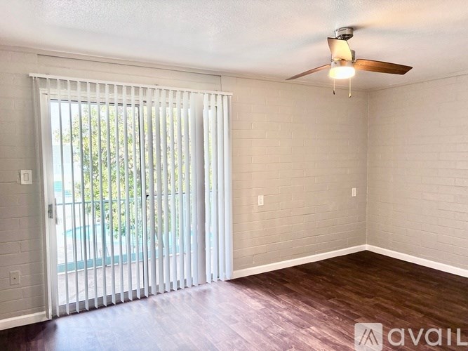 A room with a sliding door leading to a pool.