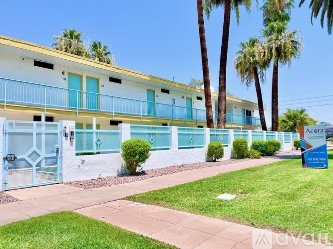 A row of houses with blue and white balconies.