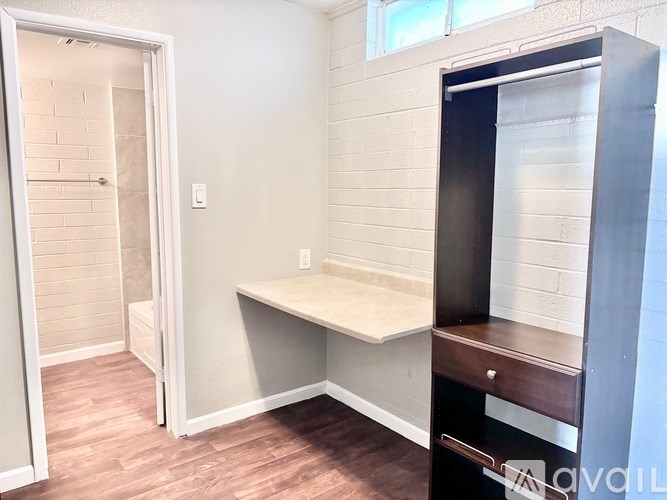 A room with a desk and a door.