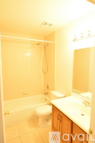 A bathroom with a toilet, sink, and bathtub.