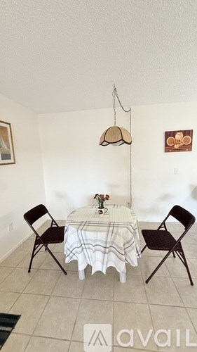 A dining room with a round table and chairs.