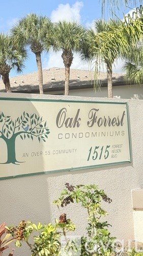 A building with a sign that reads "Clubhouse" is in front of a flagpole with an American flag.