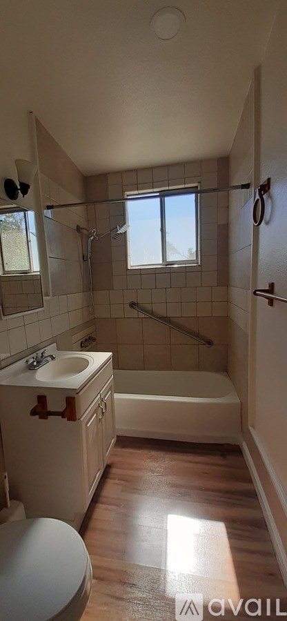 A bathroom with a toilet, sink, and bathtub.