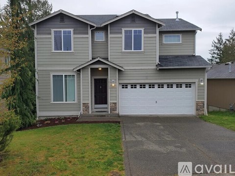 A two-story house with a garage is available for rent.