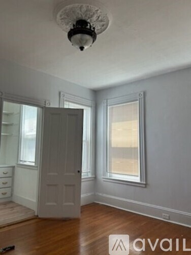 A room with a white door and a window.