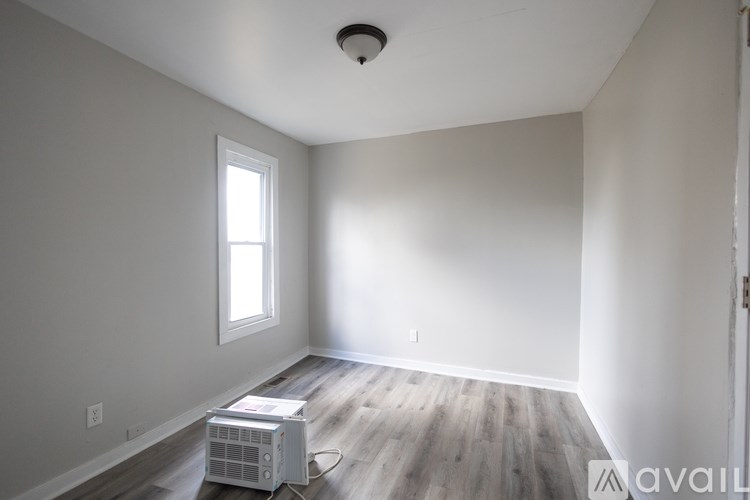 A room with a window and a ceiling fan.