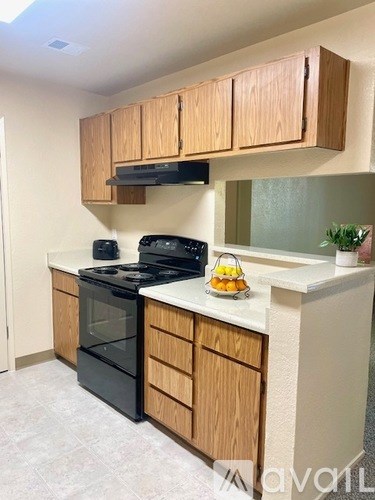 A kitchen with wooden cabinets and a black stove top.