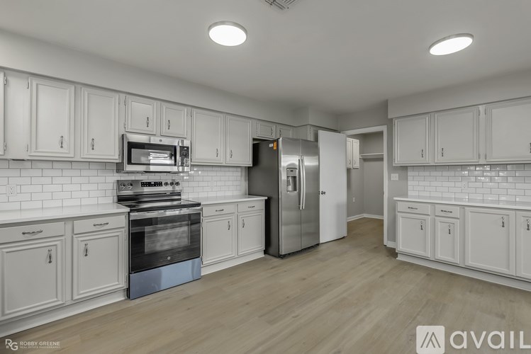 A kitchen with white cabinets and stainless steel appliances.