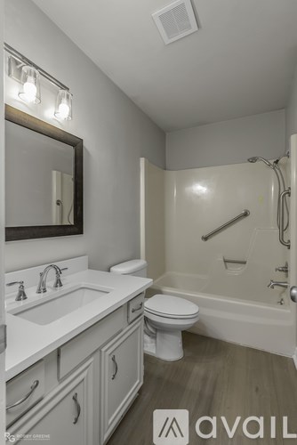 A bathroom with a toilet, sink, and bathtub.