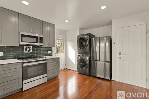 A kitchen with a stove top oven and a microwave above it.