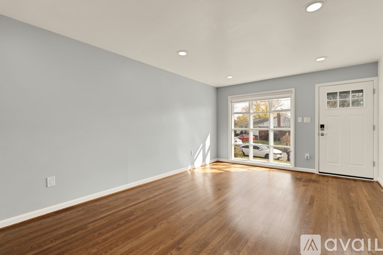 A room with wooden floors and a white door.