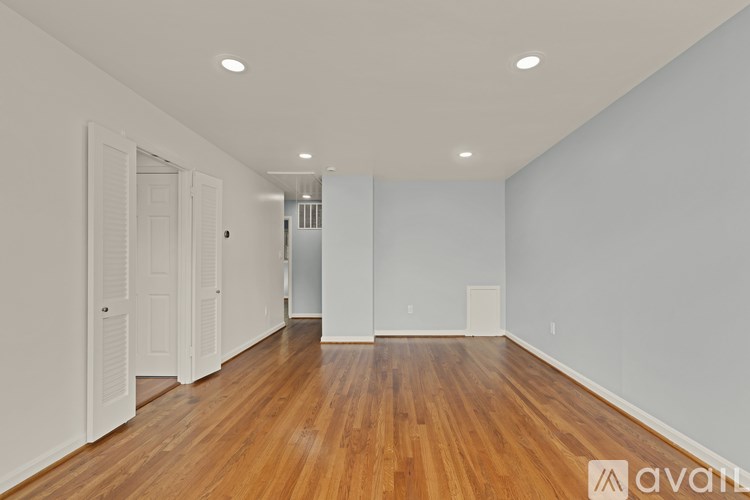A room with wooden floors and white walls.