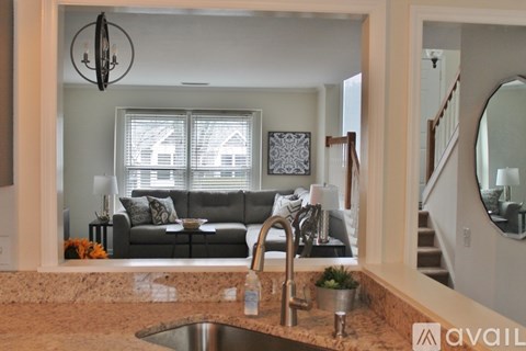 A kitchen with a sink and a mirror.