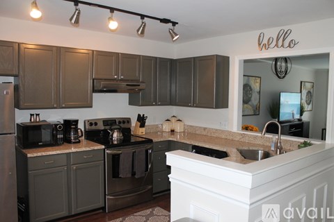 A kitchen with brown cabinets and a white island.