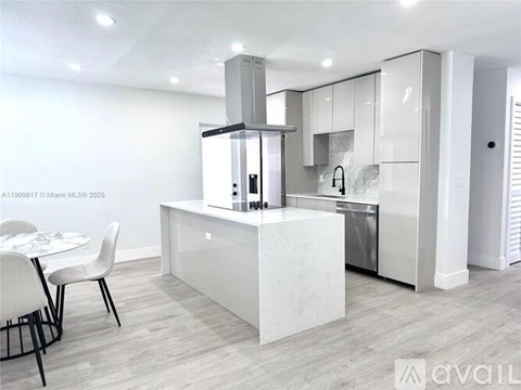 A modern kitchen with a dining table and chairs.