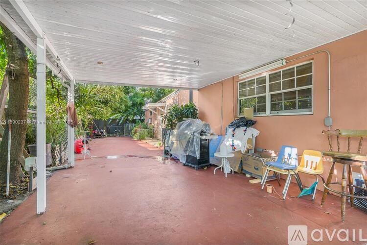 A covered patio area with a red floor and white ceiling.
