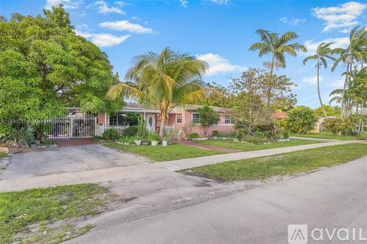 A residential area with houses and palm trees.