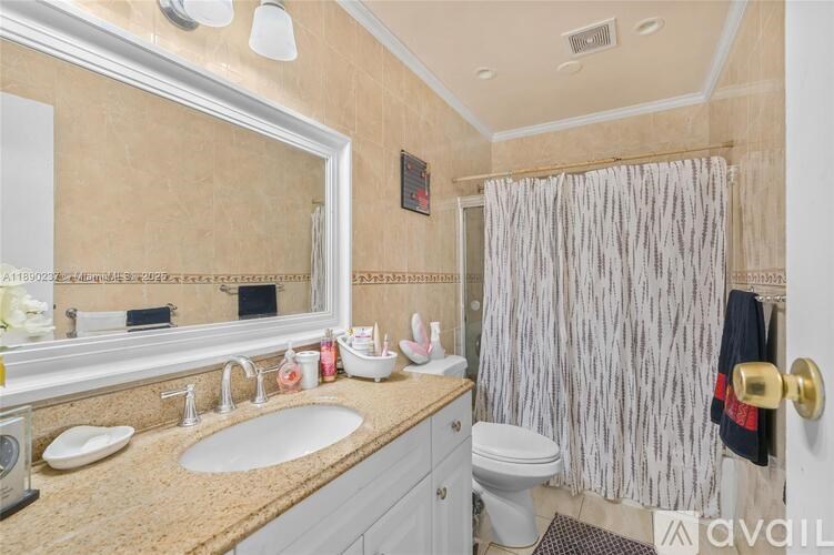 A bathroom with a sink, toilet, and shower.