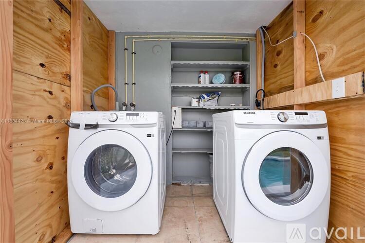 A washing machine and dryer in a small laundry room.
