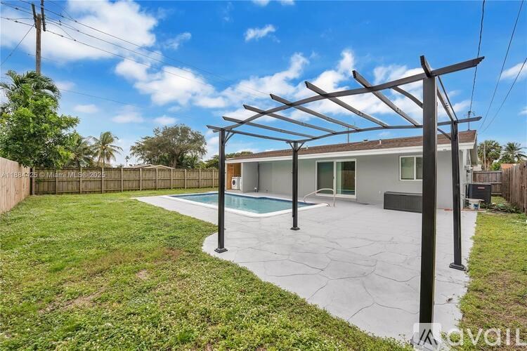 A house with a pool and a pergola.