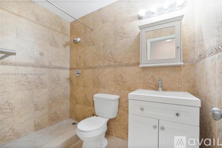 A bathroom with a toilet, sink, and a shower.