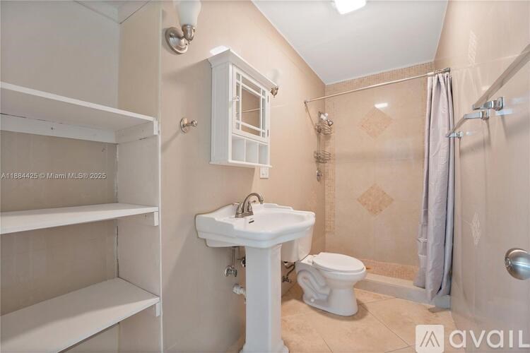 A bathroom with a sink, toilet, and shower.
