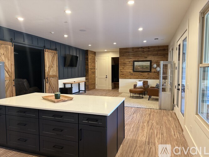 A modern kitchen with a large island and wooden accents.