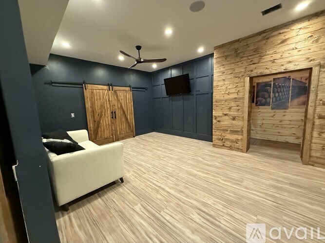 A room with a white couch and a wooden door.