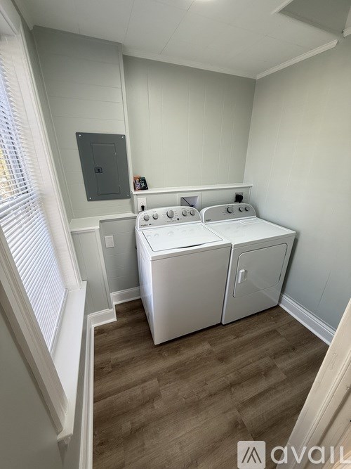 A small laundry room with a washer and dryer.
