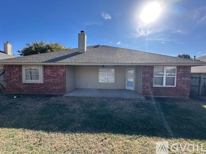 A house with a red brick exterior and a grey roof.