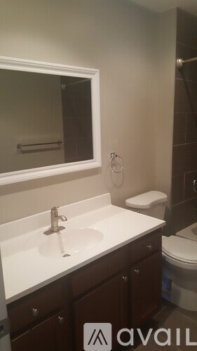 A bathroom with a sink, mirror, and toilet.