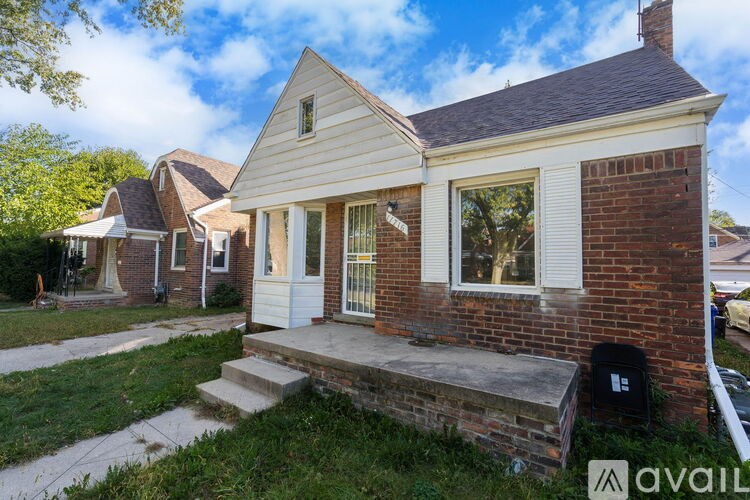 A house with a brick facade and a white door is for sale.