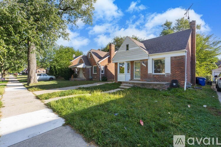 A house with a white door and a brick chimney is for sale.