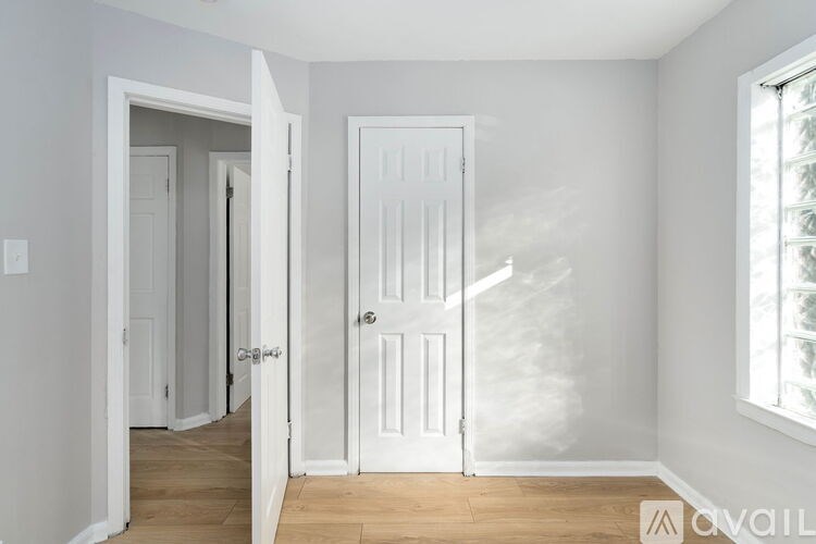 A white door is open to a hallway.