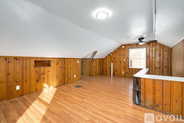 A spacious room with wooden walls and floor.