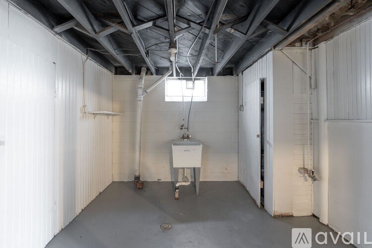 A room with a sink and a window.