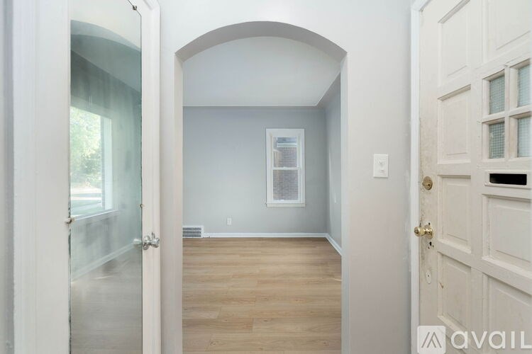 A room with a white door and a window with a white frame.