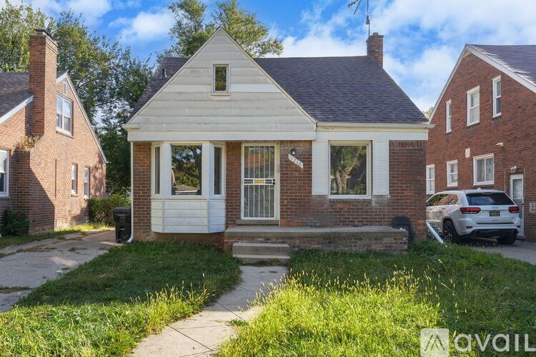 A house with a white front porch and a brick exterior is shown.