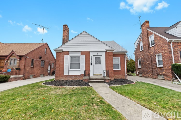 A house with a white door and a small front yard.