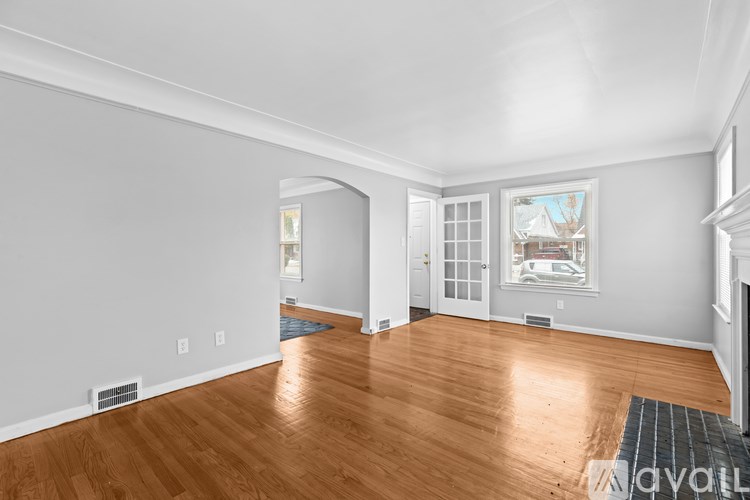 A room with wooden floors and white walls.