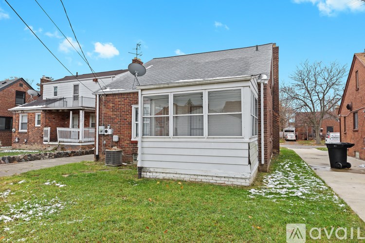 A house with a grey roof and a white porch.
