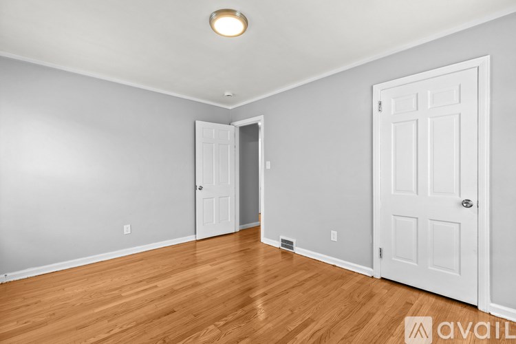 A room with two doors and a wooden floor.