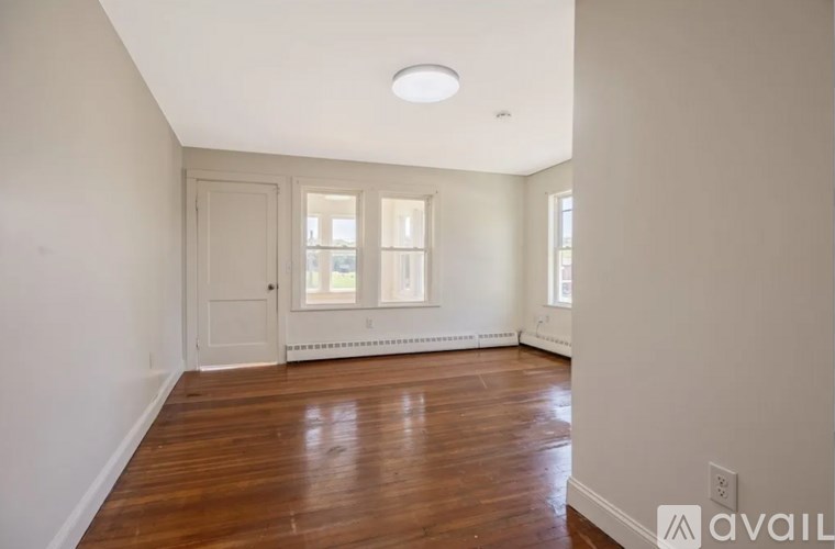 A room with wooden floors and white walls.