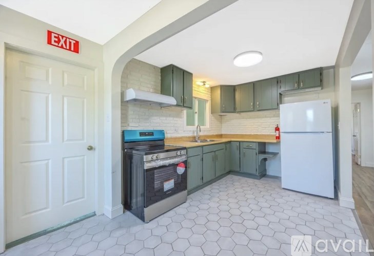 A kitchen with a white fridge and a black dishwasher.