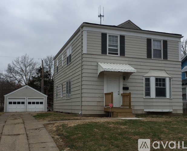 A house with a garage and a carport is for sale.