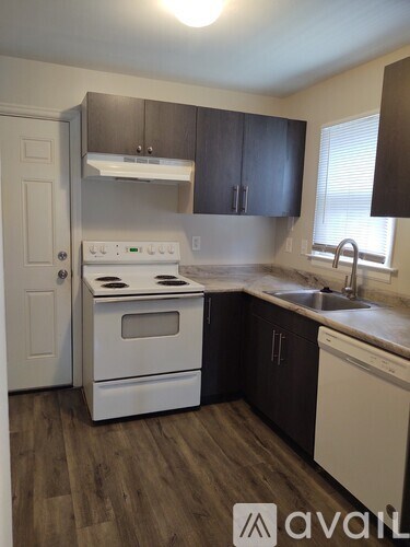 A kitchen with a white oven and black cabinets.