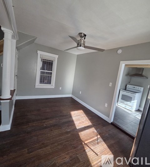 A room with a ceiling fan and a window.