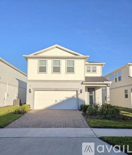 A modern house with a white facade and a garage door.