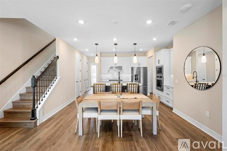 A modern kitchen with a dining table and chairs.