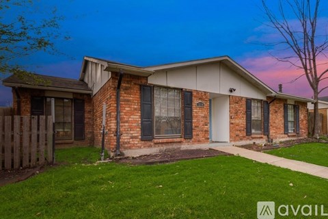 A house with a brick facade and a white door is available for rent.